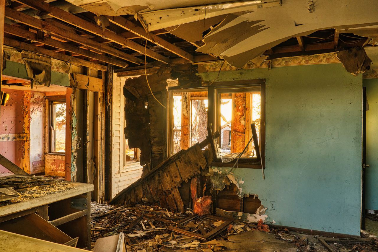Home interior destroyed by storm and flood damage with a collapsed ceiling